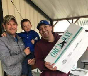 Salmon is distributed to a young family in Craig. Photo courtesy of President Clint Cook, Craig Tribal Association.